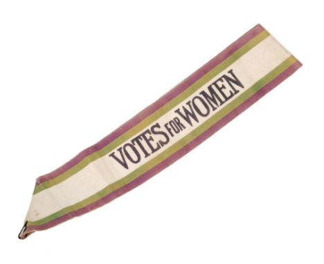 An early 20th Century woven Votes for Women sash, the white central band printed with black capital letters with green and pu