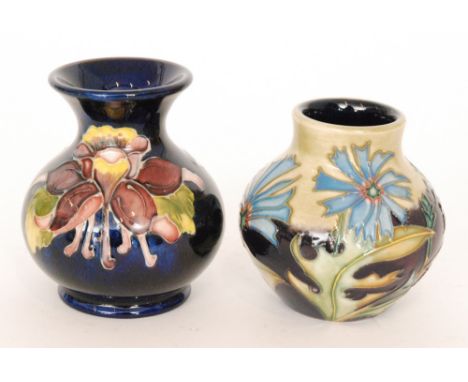 Two small Moorcroft vases, the first decorated in the Columbine pattern, the second in the Chicory pattern designed by Philip