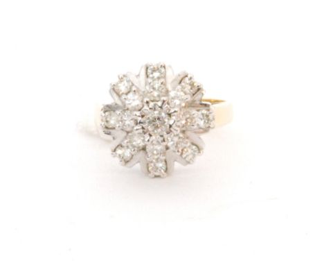 A later 20th Century 18ct hallmarked diamond cluster ring, seventeen brilliant cut diamonds in a stylised star design to a wh