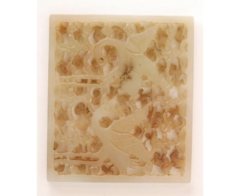 A Chinese Celadon jade  rectangular panel depicting two playful cranes or He with their wings spread against a pierced and ca