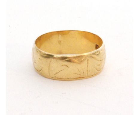 An 18ct hallmarked D shaped wedding ring with part engraved decoration, weight 6.2g, Birmingham 1976. 