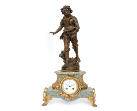 A late 19th to early 20th French spelter gilt mantle clock modelled with a figure of a boy holding his hat with a nest of chi