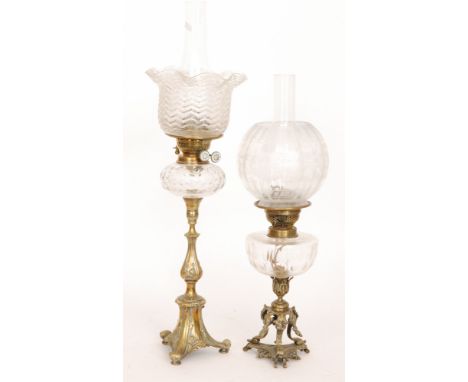 A Victorian brass oil with ribbed floral shade baluster brass column on scroll base, height 51cm, also a similar oil lamp wit