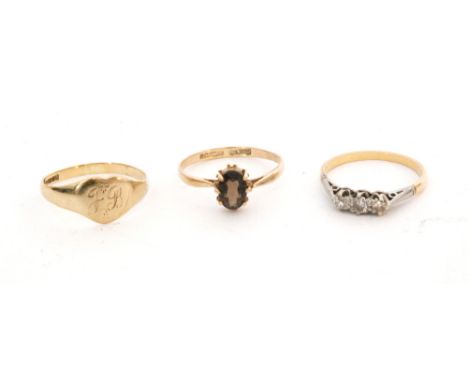 An 18ct diamond three stone ring, weight 1.7g, together with two further 9ct examples, weight 2.4g. (3)
