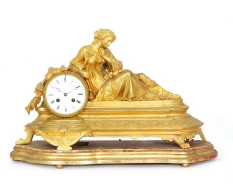 A French 19th Century gilded bronzed eight day strike mantle clock, Roman numerals to a white enamelled dial with a reclining