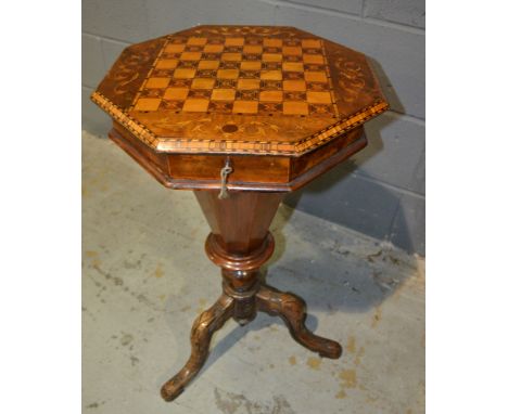 A Victorian walnut octagonal work table, the chequer board and marquetry inlaid top enclosing a fitted interior, over a turne