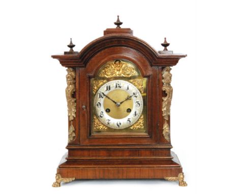 A 19th Century mahogany eight day strike mantle clock, Arabic numerals to a silvered chapter ring and brass dial below arch t