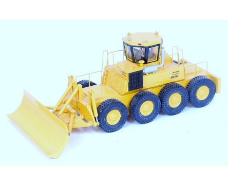 An EMD 1/50 scale resin and white metal factory built model of a Melroe M870 8-wheel skid steer bulldozer appears as issued i