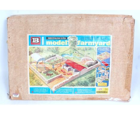 A Britains No. 4711 Britains model farm yard play set comprising of plastic play base with various stonewall sections, and a 
