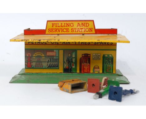 A Dinky Toys No. 48 pre-war filling and service station comprising of yellow and orange body raised on green tinplate base wi