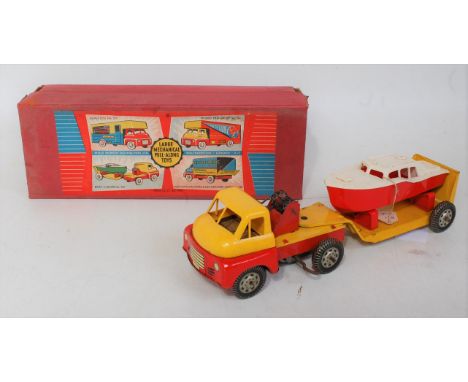 A Wells Brimtoy No. 707 tinplate and clockwork boat carrier comprising Bedford style tinplate and plastic tractor unit with l