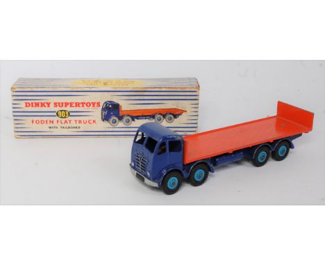 A Dinky Toys No. 903 Foden flat truck with tailboard comprising second type cab finished in dark blue with dark blue chassis,