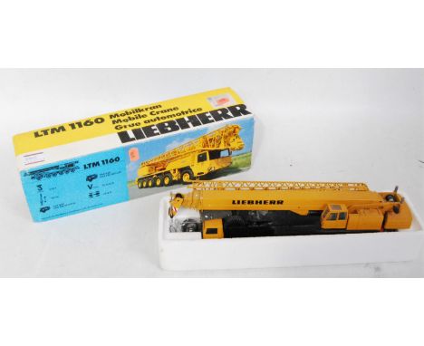 A Conrad No. 2082 1/50 scale model of a Liebherr LTM 1160 6-axle mobile crane, comprising yellow and black body with black hu