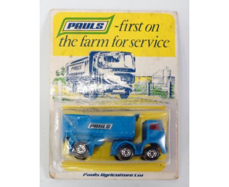 A Matchbox 1980s release No. 60 of a Pauls articulated tractor unit and trailer, finished in blue with red glazing housed on 