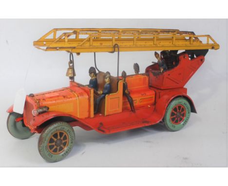 A Karl Bub circa 1930s tinplate and clockwork model of a large scale fire engine, comprising of red body with yellow detailin
