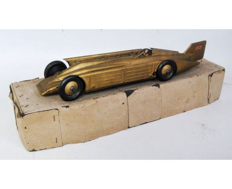 A Gunthermann tinplate and clockwork Golden Arrow Landspeed record car, appears complete with gold body, gold hubs, and drive