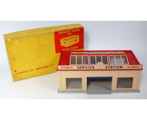 A Dinky Toys No. 785 Service Station moulded kit comprising cream and red body with clear glazing and grey base, fitted with 