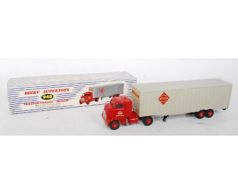 A Dinky Toys No. 948 McLean articulated tractor and trailer comprising red cab and chassis with grey trailer fitted with matc