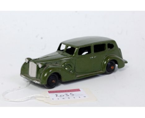 A Dinky Toys No. 39A Packard Super Eight saloon comprising of dark green body with silvered grille and black hubs, loose exam