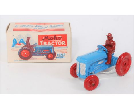 A Moko Products scale model of a tractor finished in red and blue with dark red driver figure, housed in the original all-car