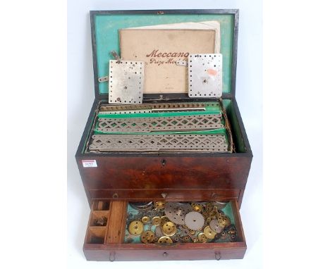 A mahogany collectors chest containing a quantity of various early 20th century base metal Meccano to include a part complete