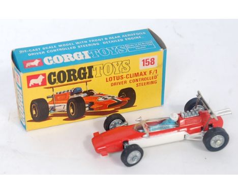 A Corgi Toys No. 158 Lotus Climax F1 racing car comprising of orange and white body with blue driver and cast hubs, no racing