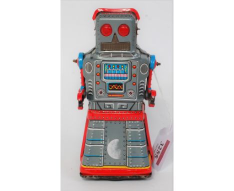 A KO Yoshiya tin plate and friction drive Atom Robot with skirted legs, comprising silver body with red, blue and yellow deta