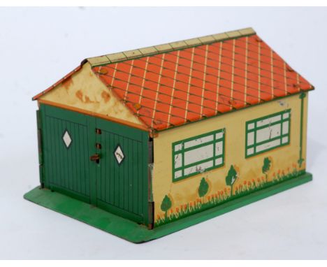 A Dinky Toys pre-war No. 45 garage, comprising of cream walls with orange roof and detailed tin printed sides, with silvered 