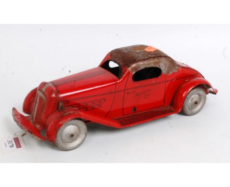 A 1930s Wolverine Manufacturing Company tinplate and friction winding drive Mystery car, finished in red and black with silve