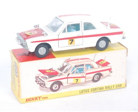 A Dinky Toys No. 205 Lotus Cortina Rally car comprising red and white body with light blue interior and twin aerials to boot,