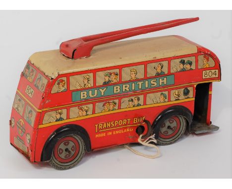 A Brimtoy tin plate and clockwork double decker trolley bus comprising of red body with detailed passenger tin printing with 
