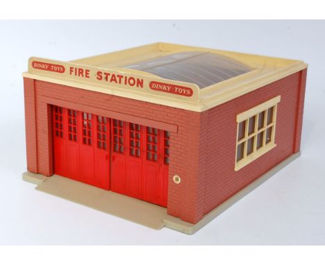 A Dinky Toys No. 954 fire station comprising of brickwork effect plastic body with cream roof and Dinky Toys fire station sig