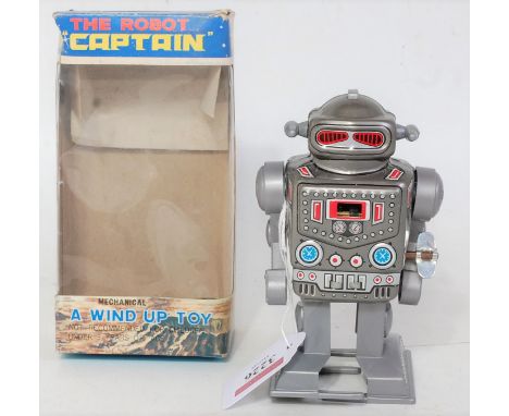 A Yoneya tin plate and plastic Model No. 2121 Captain Robot, finished with a tin plate silver and tin printed body with plast