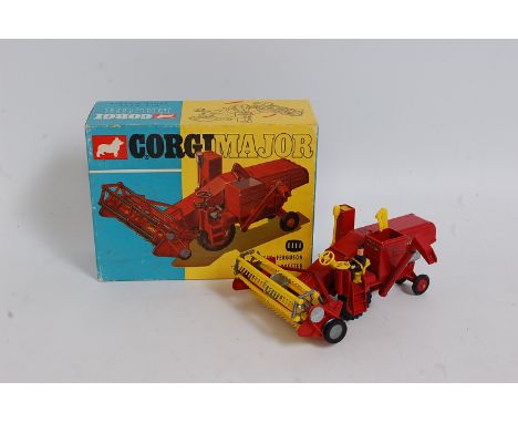 A Corgi Toys No. 1111 Massey Ferguson 780 combine harvester comprising of dark red body with yellow tines and dark red plasti