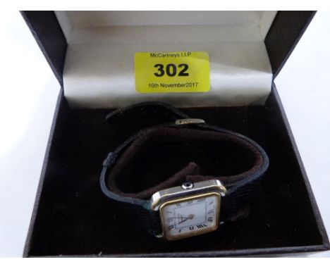 A Longines lady's wristwatch, the two colour tank case with enamel dial and Roman numerals, the crown with a blue cabochon. M