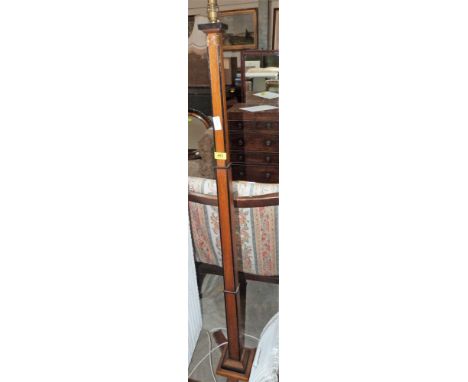 An Art Deco oak and ebonised lamp standard