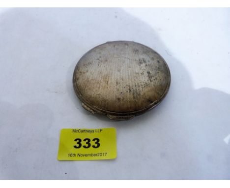 A silver engine turned powder compact