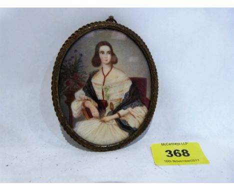 A 19th century portrait miniature on ivory of a young lady seated. Three quarter length. 4'' high