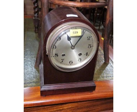 A mahogany dome cased mantle clock, the movement striking and chiming on six gongs. 13'' high