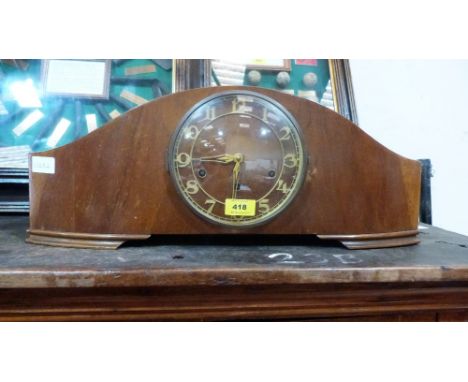An Art Deco design walnut mantle clock. 23'' wide