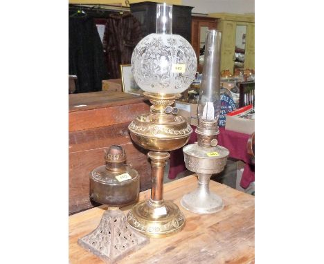 A brass oil lamp and two others