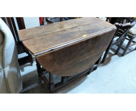 An 18th century joined oak gate leg table on baluster turned legs. 42'' wide