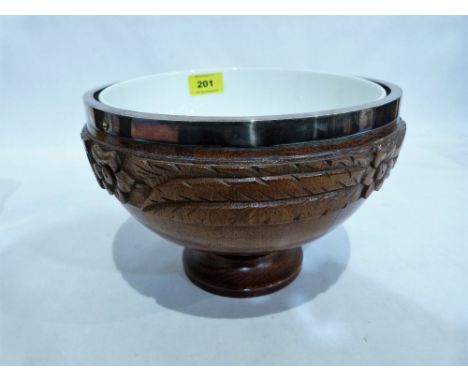 An early 20th century oak carved fruit bowl with ceramic liner and plated rim. 9¼'' diameter