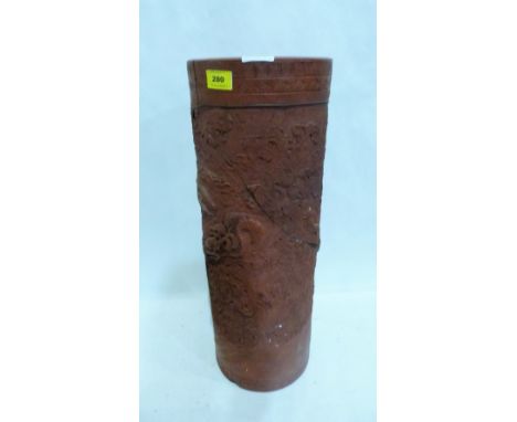 A Chinese terracotta stick stand, decorated in relief with dragons and foliage. 23'' high. Extensive damage and losses