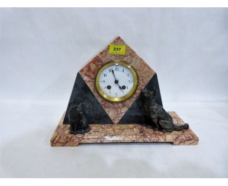 An Art Deco pink and grey marble mantle clock mounted with speltar dog and cat. French drum movement. 10½'' high
