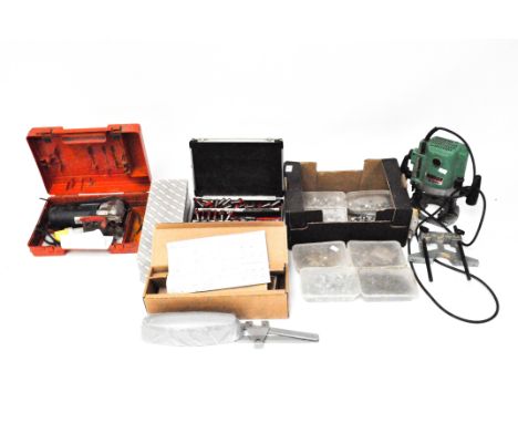 A collection of assorted tools, including a Hitachi M12SA Router, Drill bits and more