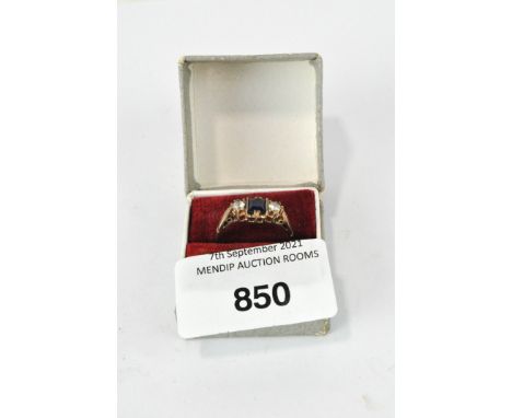 A vintage 9ct gold three stone ring, comprising a central blue square stone flanked by two white stones, 2.7g