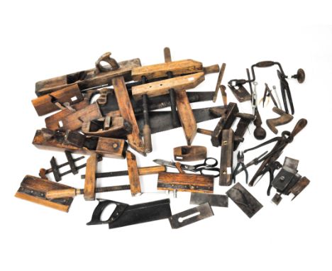 A large selection of assorted vintage tools including saws, clamps, planes, and more