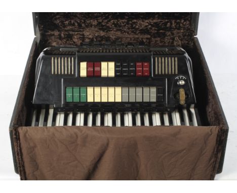 A black Farfisa Transivox electric piano accordion, model TX11M, serial no.1100/37, within a velvet lined case with leatheret