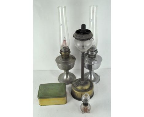 Three vintage oil lamps, one being a Super Aladdin, with glass funnel, the largest  59cm high